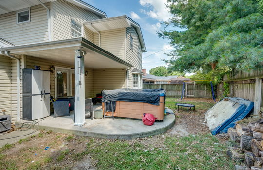 covered back porch, fenced yard, exterior entry door, vinyl siding