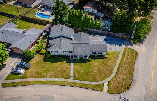 aerial photo, tri-level home, front yard, back yard, driveway, sidewalk, road, neighboring homes