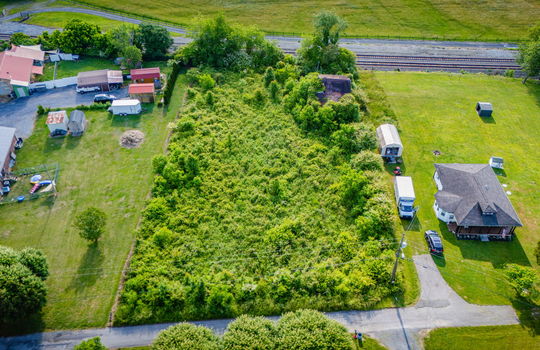 Aerial photo, 0.79 +/- acres, road, trees, barn, neighboring homes