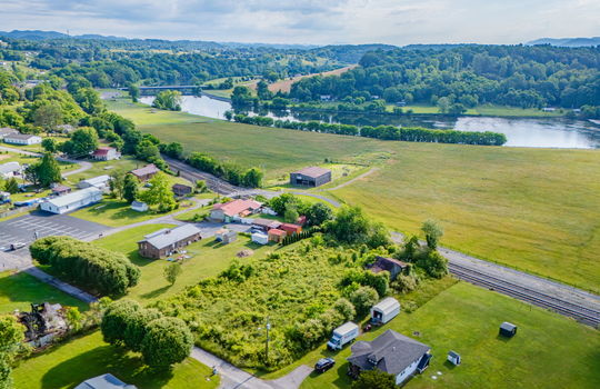 Aerial photo, 0.79 +/- acres, road, trees, barn, neighboring homes, mountain views, river views