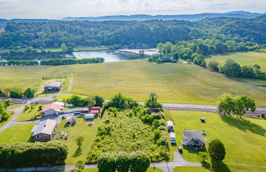 Aerial photo, 0.79 +/- acres, road, trees, barn, neighboring homes, mountain views, river views