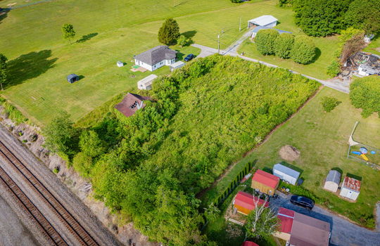 Aerial photo, 0.79 +/- acres, road, trees, barn, neighboring homes, train tracks
