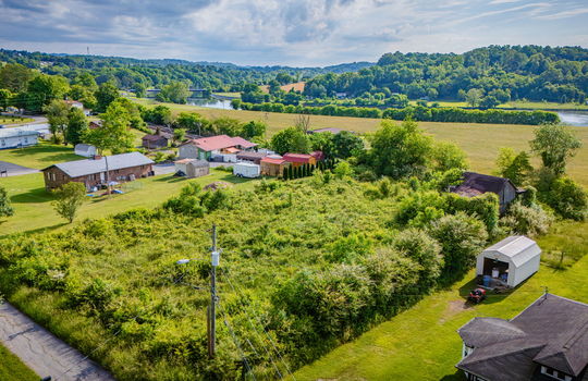 Aerial photo, 0.79 +/- acres, road, trees, barn, neighboring homes, mountain views, river views