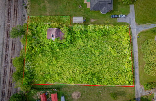 Aerial photo, 0.79 +/- acres, road, trees, barn, neighboring homes, property outline