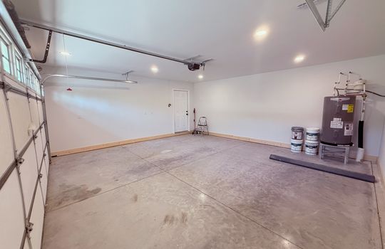 garage, garage door, concrete flooring, recessed lighting, interior entry door