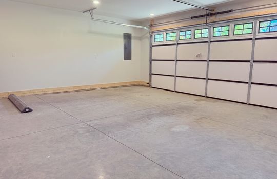 garage, garage door, concrete flooring, recessed lighting