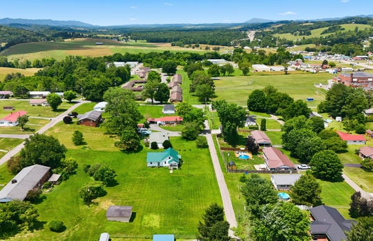Aerial photo, land, 0.331+/- acres, neighboring homes, road, trees, mountains