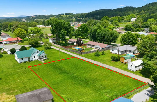 Aerial photo, land, 0.331+/- acres, neighboring homes, road, trees, mountains, property outline