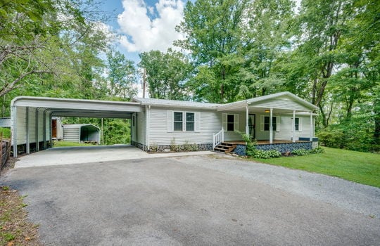 driveway, double wide, vinyl siding, covered front porch, carport, front yard