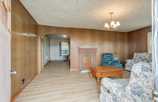 living room, paneling walls, arched doorway, driveway, windows