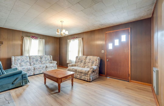 living room, paneling walls, windows, front door