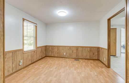 dining space, laminate flooring, window, doorway to kitchen