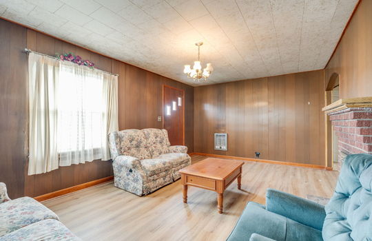 living room, front door, window, fireplace, arched doorway