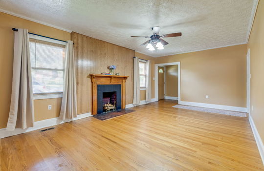 living room, entry/foyer, ceiling fan, fireplace, hardwood flooring