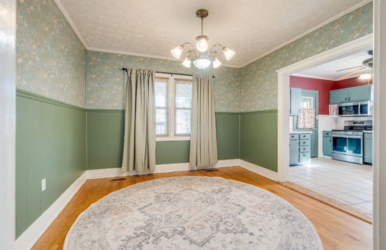 cining room, hardwood flooring, windows, chandelier, doorway to kitchen