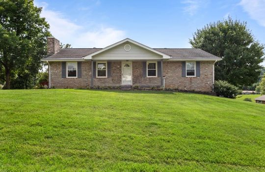 Brick, ranch, front yard, covered front porch, landscaping, trees