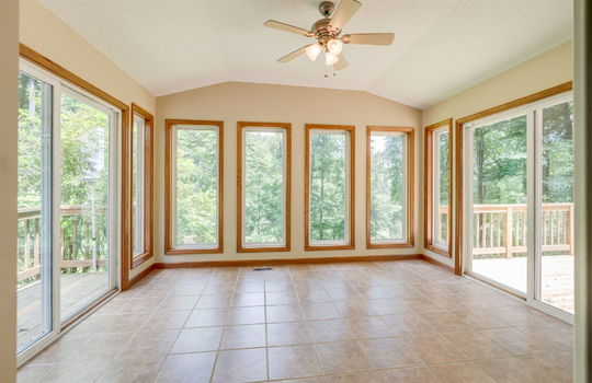 Sunroom, tile flooring, ceiling fan, windows, glass sliding doors