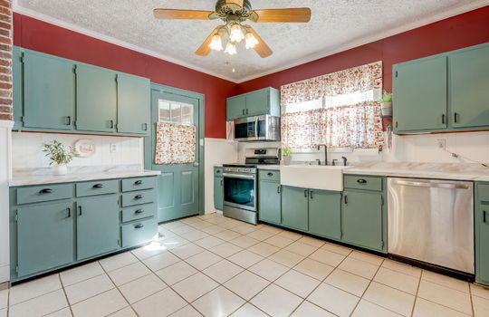 Kitchen, cabinets, apron sink, stainless appliances, dishwasher, electric range, built-in microwave, windows, sink