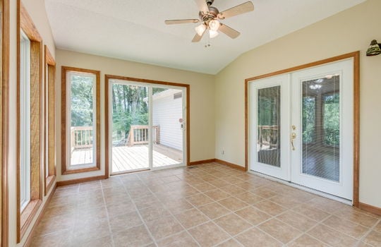 sunroom, ceiling fan, tile flooring, double door entry, sliding glass doors, windows