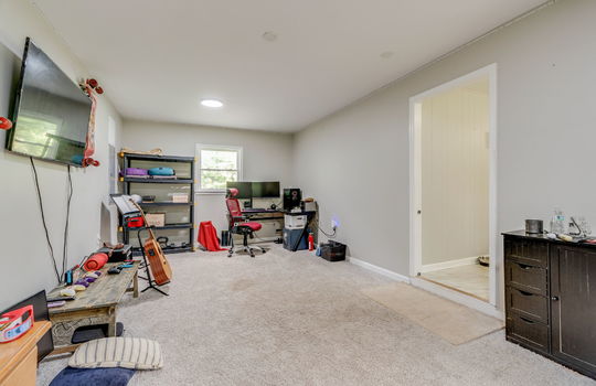 bonus room, carpet, window, doorway to kitchen