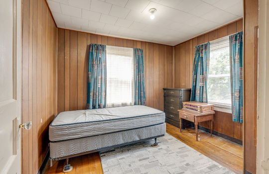 bedroom, hardwood flooring, paneling walls, windows