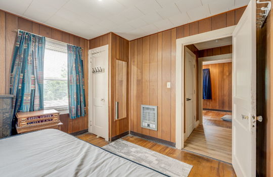 bedroom, closet, paneling walls, hardwood flooring