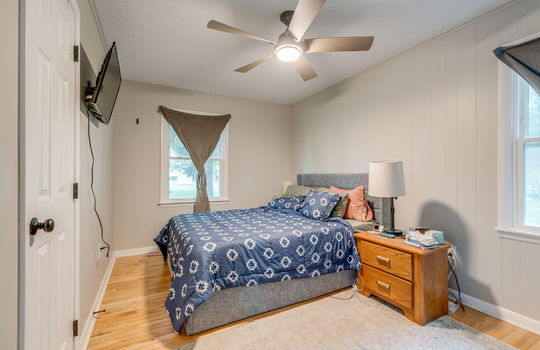 bedroom, hardwood flooring, painted paneling walls, windows, ceiling fan, closet