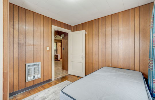 bedroom, paneling walls, hardwood flooring, radiant heating