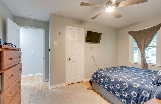 bedroom, hardwood flooring, closet, window, ceiling fan