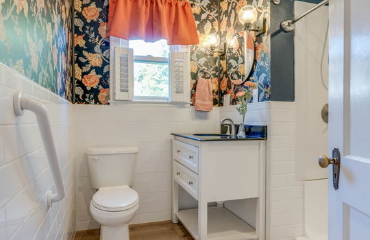 bathroom, sink, shower, toilet, vinyl flooring, half tile walls