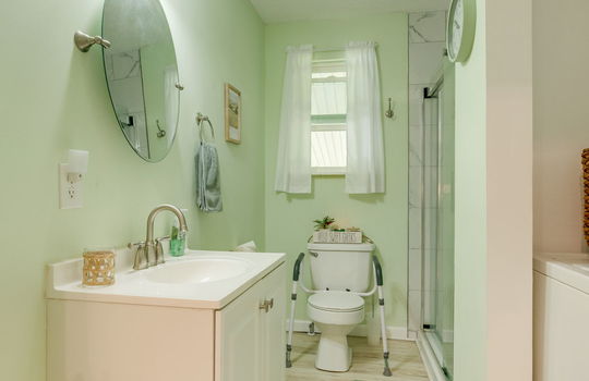 bathroom, shower, toilet, sink, luxury vinyl flooring, glass shower door, tile shower