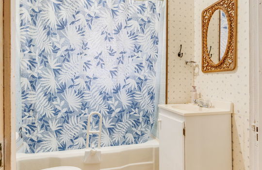 bathroom, sink, shower/tub, toilet, paneling walls, laminate flooring