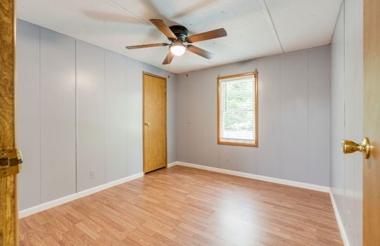 second bedroom, laminate flooring, ceiling fan, window, closet