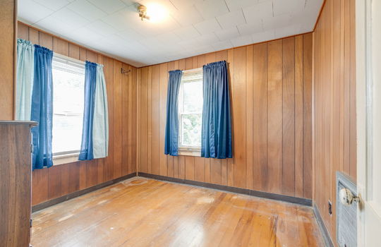 second bedroom, windows, hardwood flooring, paneling walls, radiant heating