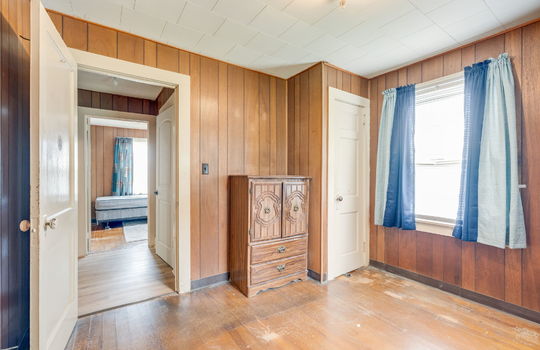 second bedroom, windows, hardwood flooring, paneling walls, radiant heating, closet