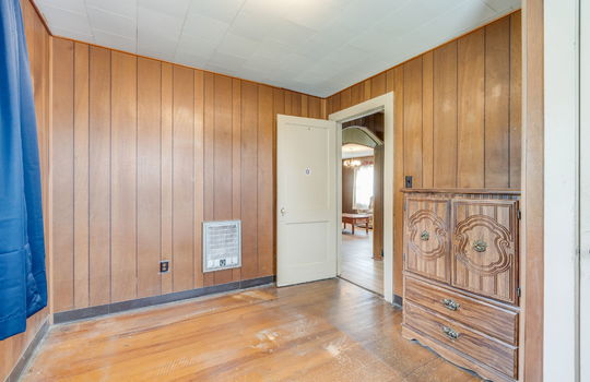 second bedroom, windows, hardwood flooring, paneling walls, radiant heating