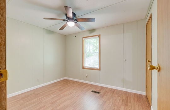 third bedroom, laminate flooring, closet, ceiling fan, window