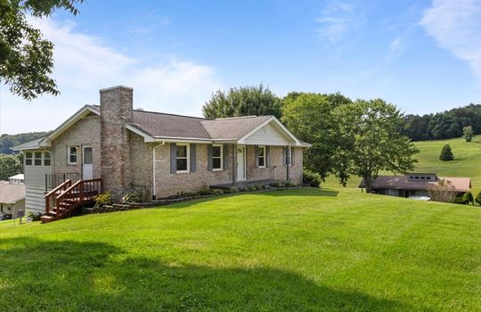 left side view of home, brick, ranch, covered front porch, side porch, side entrance, front door, landscaping, nearby homes
