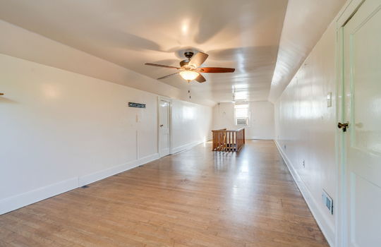 upper level bonus space, hardwood flooring, stairs, windows, ceiling fans, storage