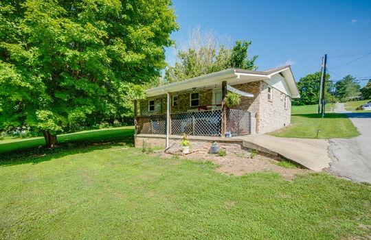 driveway, parking pad, covered back porch, back yard, trees