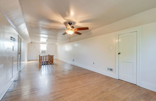 upper level bonus space, hardwood flooring, stairs, windows, ceiling fans, storage
