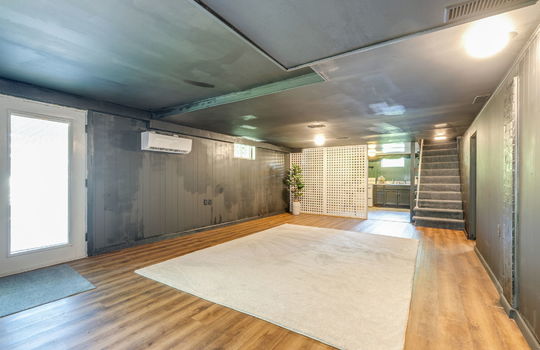 finished basement, exterior doors, vinyl flooring, stairs to main level, secondary kitchen space