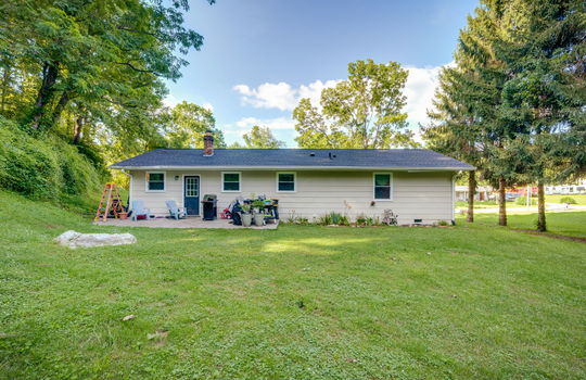 back of home, ranch, masonite exterior finish, exterior door, back patio, back yard