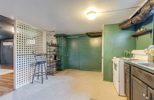 secondary kitchen, vinyl flooring, oven, sink, doorway