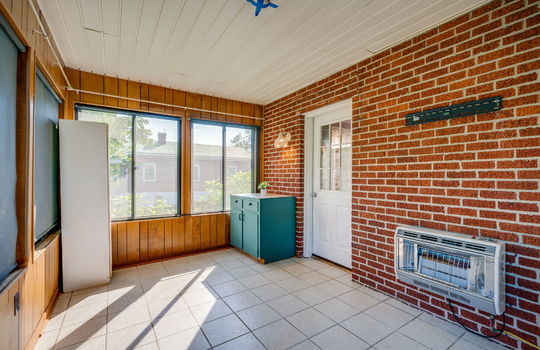enclosed sunroom, tile flooring, brick, windows