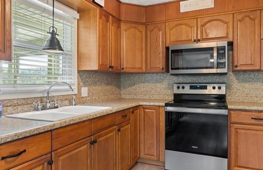 kitchen, cabinets, countertops, sink, window above sink, range/oven, built in microwave