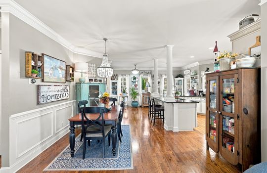 dining space, chandelier, hardwood flooring, open to kitchen, kitchen island