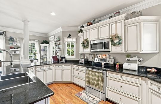 kitchen, granite countertops, cabinets, stainless steel appliances, oven/range, built-in microwave, sink in island, hardwood flooring, exterior door