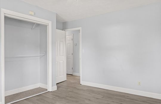 bedroom, closet, luxury vinyl flooring, doorway to hall