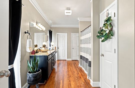 primary bathroom, sink, toilet, shower/tub, walk in -closet, linen closet, windows, hardwood flooring